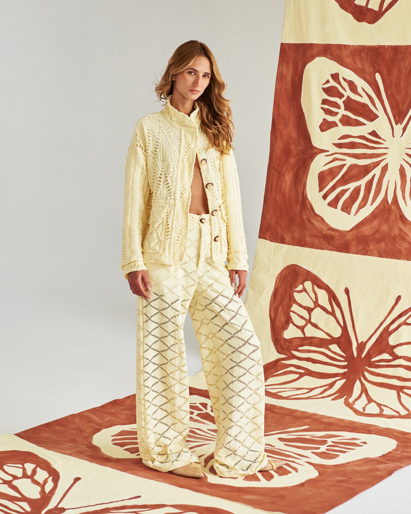 Chaqueta artesanal tejida a mano en tono arena, con detalles calados que la hacen ligera y sofisticada. Botones naturales y un corte relajado para un look fresco, cómodo y elegante. Perfecta para un estilo mediterráneo chic que te acompaña del día a la noche.&nbsp;